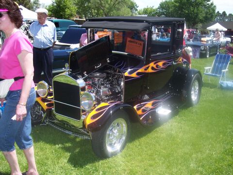 1972 Ford Ranchero - Customized hot rod with flame paint and exposed engine at a car show.