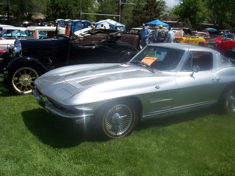 1972 Ford Ranchero - A silver coupe with racing stripes is parked on grass at a car show next to a black vintage car.