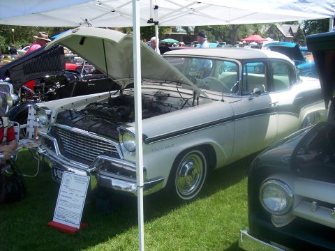 1972 Ford Ranchero - A 1957 Studebaker Golden Hawk is displayed with its hood open at a car show.