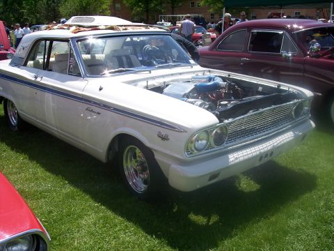1972 Ford Ranchero - White 1963 Ford Falcon displayed at a car show with its engine exposed.