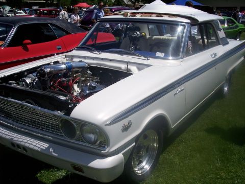 1972 Ford Ranchero - A white 1962 Ford Fairlane coupe is displayed with its hood open, revealing the engine.
