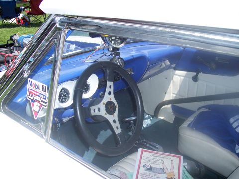 1972 Ford Ranchero - The interior of a 1972 Ford Ranchero features a custom steering wheel, racing gauges, and blue and white upholstery.