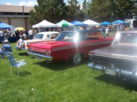 1972 Ford Ranchero - A red 1964 Ford Fairlane 500 coupe with a black vinyl top is parked at an outdoor car show.