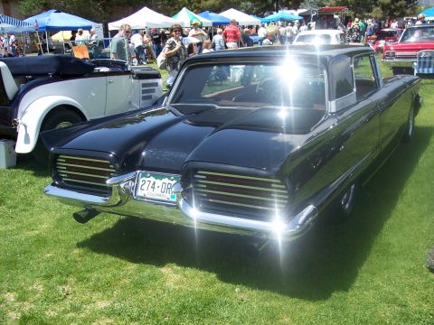 1972 Ford Ranchero - Black 1960 Ford Thunderbird at a car show, with other vehicles and tents in the background.