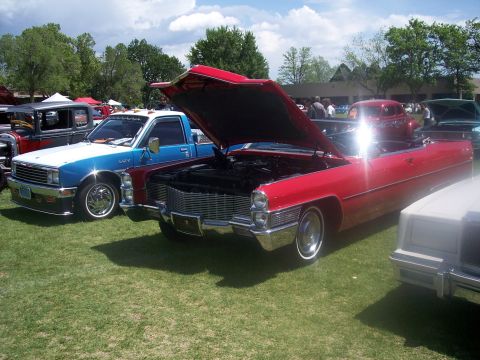 1972 Ford Ranchero - A red 1967 Cadillac convertible is displayed with its hood open at an outdoor car show.