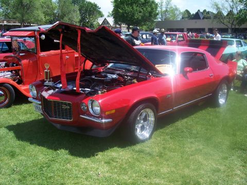 1972 Ford Ranchero - A red muscle car is displayed with its hood open at an outdoor car show.