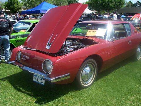 1972 Ford Ranchero - A red 1963 Studebaker Avanti is displayed with its hood open at a car show.