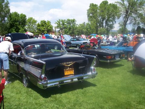 1972 Ford Ranchero - Multiple classic cars are displayed on a grassy field under a partly cloudy sky at an outdoor car show.