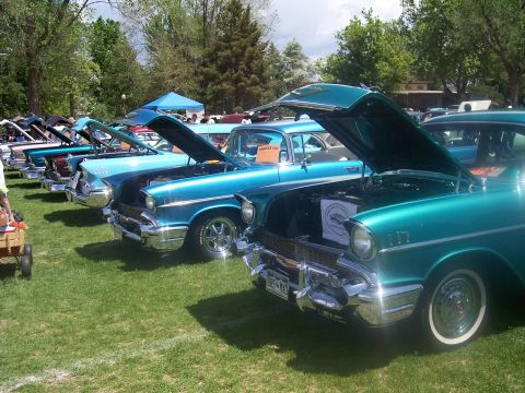 1972 Ford Ranchero - Multiple classic Chevrolet Bel Airs are displayed with hoods open at an outdoor car show.