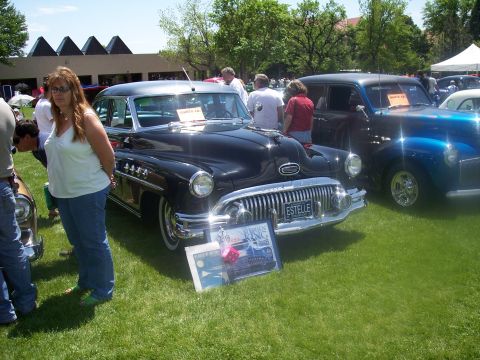 1972 Ford Ranchero - Black 1951 Buick sedan on display at a car show, with a blue car beside it.