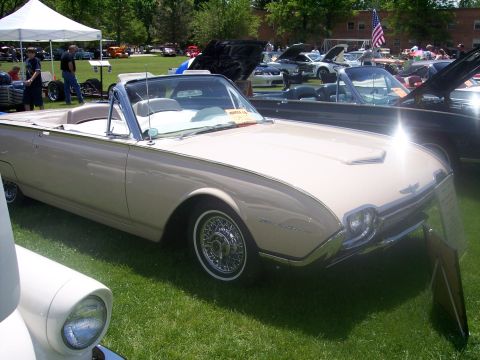 1972 Ford Ranchero - A tan 1961 Ford Thunderbird convertible is displayed at a car show with other vehicles present.