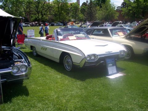1972 Ford Ranchero - A white 1961 Ford Thunderbird convertible is displayed at a car show with other vehicles.