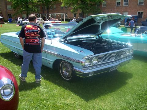 1972 Ford Ranchero - A light blue 1963 Ford Galaxie convertible is displayed with its hood open at a car show.