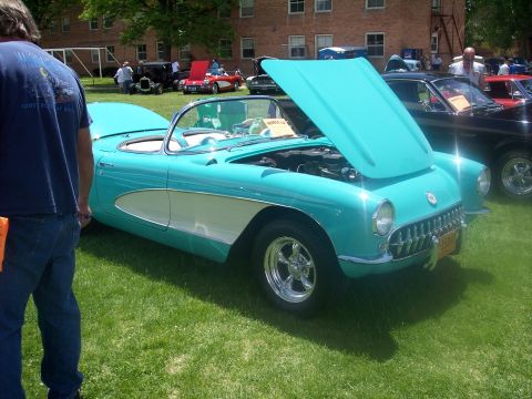1972 Ford Ranchero - A turquoise 1957 Chevrolet Corvette is displayed with its hood open at an outdoor car show.