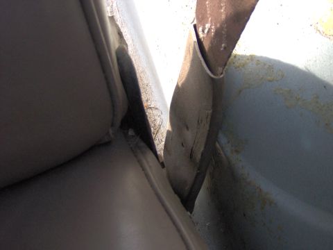 1993 Ford Bronco - Close-up view of the interior door panel and seat, showing a gap and some wear.