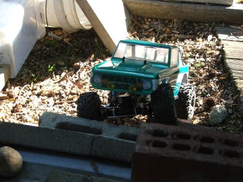 1996 Ford Bronco - RC rock crawler truck with KC lights is positioned on a rocky surface.