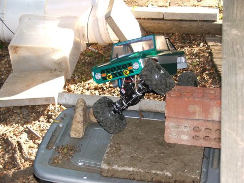 1996 Ford Bronco - An RC car body resembling a classic SUV is mounted on a chassis with large off-road tires.