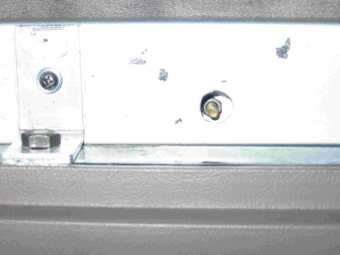 1993 Ford Bronco - I drilled behind the button location with a 1/2 inch bit so that I could sneak a socket in to tighten the nut on the back of the button scr…