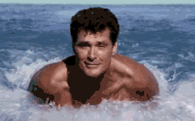 1991 Ford Bronco - David Hasselhoff is seen in the ocean, with water splashing around him.