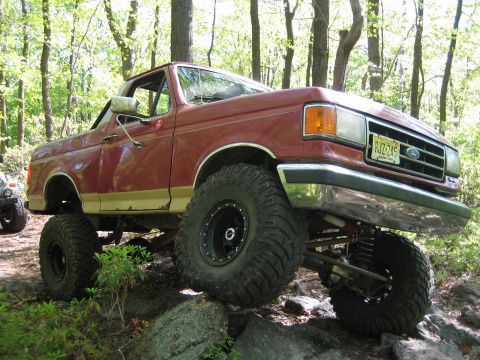 1990 Ford Bronco - This lifted 1990 Ford Bronco is shown off-roading on a rocky trail.