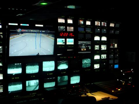 2000 Ford Taurus - A video control room displays multiple screens, including a hockey game and a clock, with various controls visible.