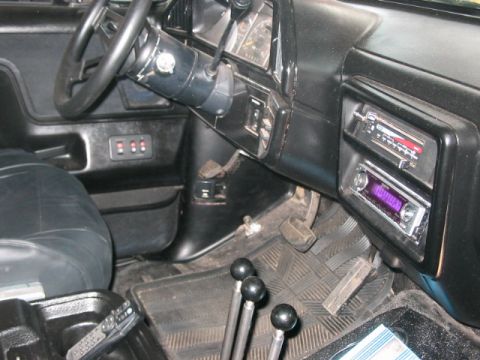 1991 Ford Bronco - Interior view of a 1991 Ford Bronco, aftermarket audio equipment and a manual transmission setup.