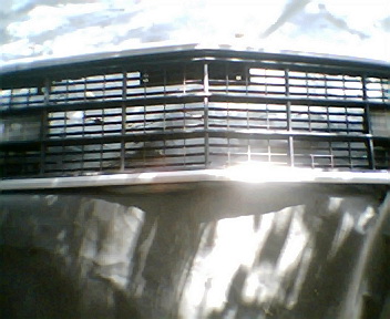 1973 Ford Ranchero - Close-up of a vehicle's front grille, showing its intricate horizontal bar design.