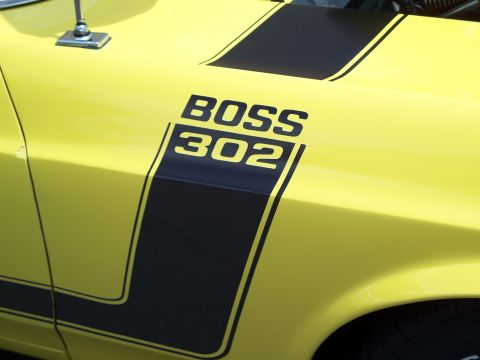 1971 Ford Ranchero - Close-up of a yellow car's fender a "BOSS 302" decal and racing stripes.