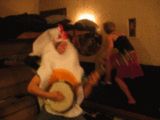 1987 Suzuki Samurai - A person dressed in a costume plays a banjo in a dimly lit room.