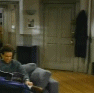 1987 Suzuki Samurai - A man relaxes on a couch in a dimly lit living room.