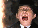 1987 Suzuki Samurai - A child wearing a hat and glasses screams with their mouth wide open, illuminated by a bright light source.
