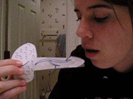 1987 Suzuki Samurai - A young woman holds a handmade papercraft with blue lines and writing on it.