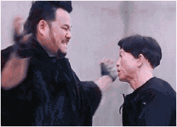 1987 Suzuki Samurai - Two men in a confrontation, one delivering a slap to the other's face.