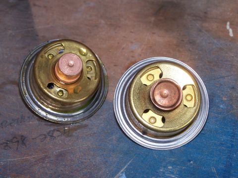 1973 Ford Ranchero - Two engine thermostats are shown side-by-side on a workbench.