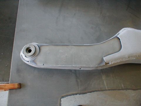 1996 Ford Bronco - A close-up view of a metal suspension control arm, likely a replacement part.