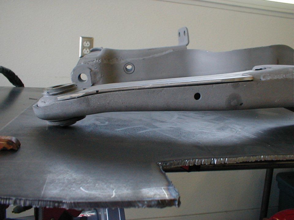 Gray suspension part with metal shim on top