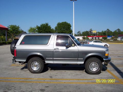 1996 Ford Bronco - This two-tone gray and silver SUV is a 1996 Ford Bronco, viewed from the side.