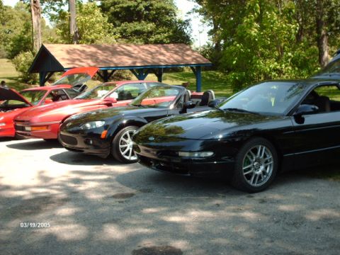 1995 Ford Probe - A black 1995 Ford Probe is parked in a line with other vehicles, viewed from the front three-quarter angle.