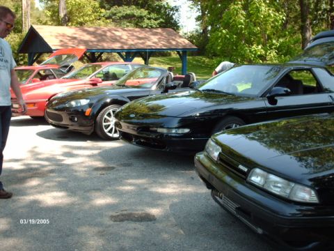 1995 Ford Probe - Several cars, including a 1995 Ford Probe, are parked together on a sunny day.