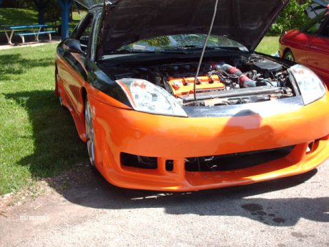1995 Ford Probe - Customized sports car with hood up, parked outdoors next to another vehicle.