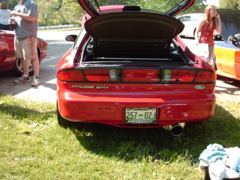 1995 Ford Probe - The rear of a red Ford Probe is shown with its trunk open, displaying the 'PROBE 24V' badge.