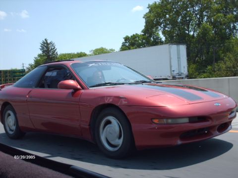 1995 Ford Probe - Red 1995 Ford Probe on highway, seen from passenger side.