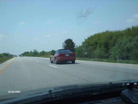 1995 Ford Probe - Red 1995 Ford Probe on the highway, captured from the perspective of a following vehicle.