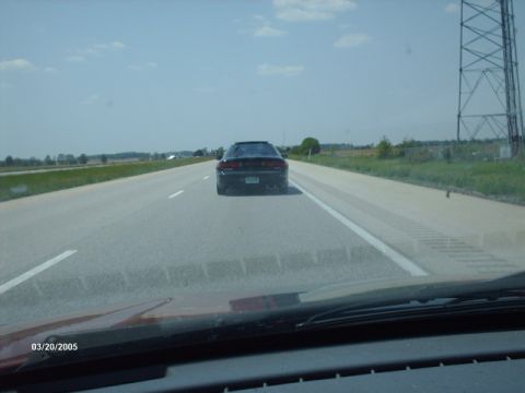 1995 Ford Probe - Driving on the highway behind a black 1995 Ford Probe on a sunny day.