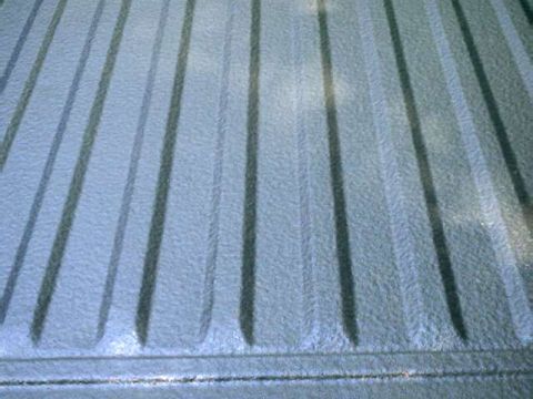 1976 Ford Ranchero - The textured surface of a truck bed liner features parallel raised ribs for grip.