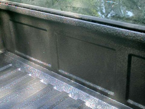 1976 Ford Ranchero - Close-up of a truck bed's interior, showing the textured liner and ribbed floor.