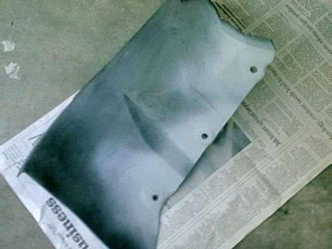 1976 Ford Ranchero - Automotive part laid on top of newspaper pages.