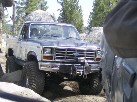1986 Ford Bronco - This 1986 Ford Bronco navigates a rocky trail, equipped with a front-mounted winch.