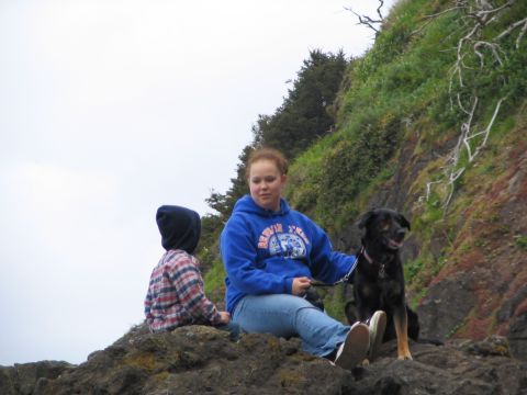 1983 Ford Bronco - A group enjoys a scenic view by the water, with a dog sitting attentively beside them.