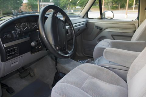 1995 Ford Bronco - Interior view of a 1995 Ford Bronco, showing the dashboard, steering wheel, and front seats.